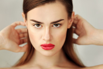 Fototapeta premium Portrait of beautiful young woman on color background, close up