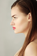 Naklejka premium Portrait of beautiful young woman on color background, close up