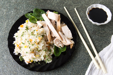 Chicken with rice and vegetables on a plate