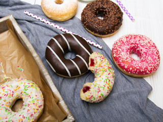 Colorful donuts with chocolate and icing, selective focus