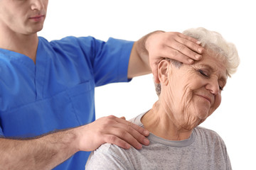 Physiotherapist working with elderly patient in clinic