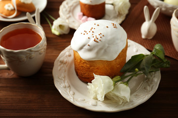 Sweet Easter cake with cup of tea on table