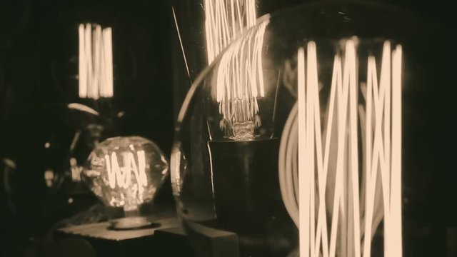Incandescent tungsten filament trembling in light bulb, creative interior design