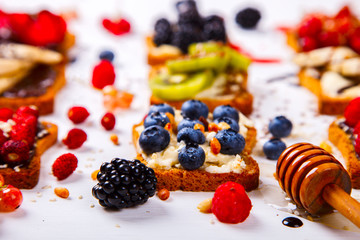  Sandwiches Set sweet with cream-cheese and fresh berries and fruit over pine Nut,a white background . Concept of Healthy Food.Breakfast snack.selective focus.