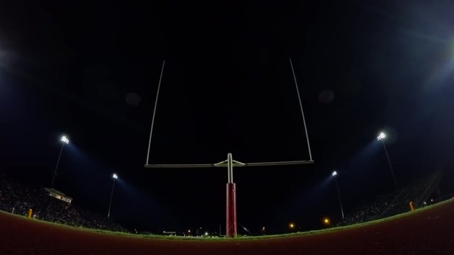 Crowded football field at night