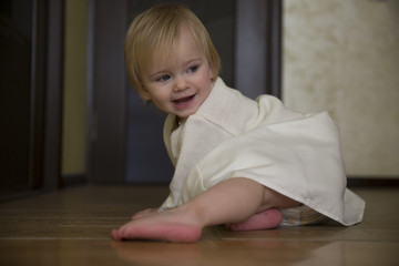 Little girl in the white dress playing with a kitten