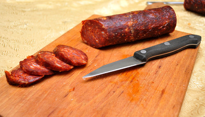 Domestic sausage cut up on the table while the sun shines, Novi Sad, Serbia
