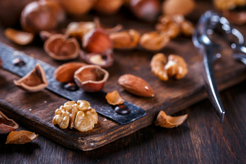 Nuts Mixed on Wooden Background.Assortment, Walnuts,Pecan,Peanuts,Almonds,Hazelnuts,Macadamia,Cashews,Pistachios.Concept of Healthy Eating.Vegetarian.selective focus.