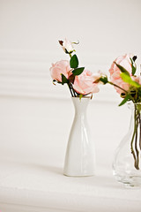 Tender ivory roses decor in a white vase