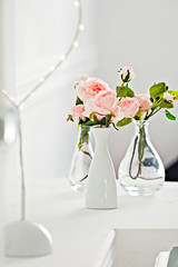 Tender ivory roses decor in a white vase