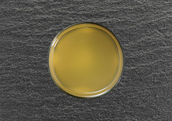 Top view of a glass of coconut water on a black slate table.