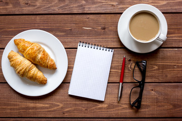 Business breakfast with coffee and croussant top view