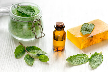 organic cosmetics with herbal extracts of mint on wooden background
