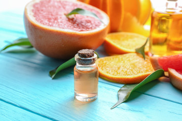 Aroma oil with citrus on color background