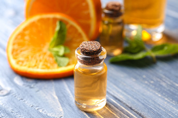 Aroma oil with citrus on color background