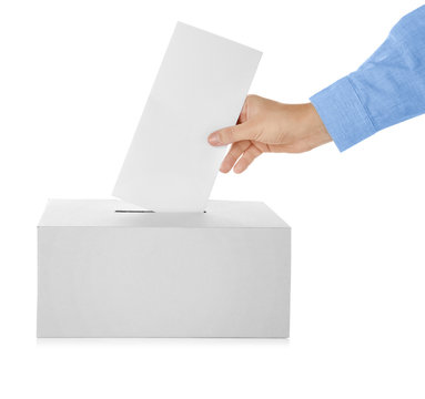 Male hand putting voting ballot into the box  on white background