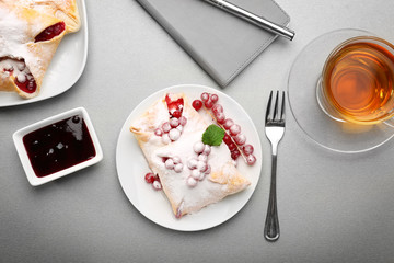 Tasty puff pastry with berries on plate