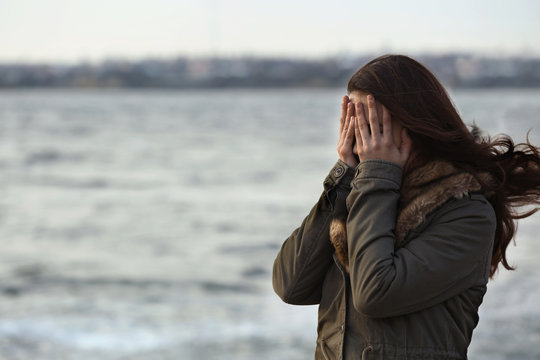 Depressed young woman on pier