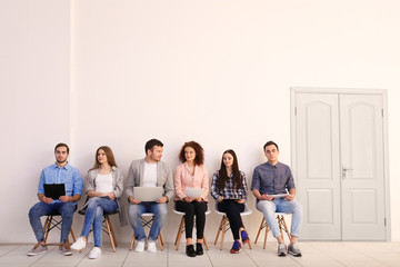 Group of people waiting for job interview in office hall