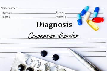 Conversion disorder - Diagnosis written on a piece of white paper with medication and Pills
