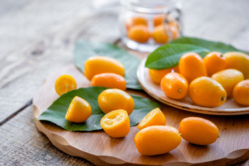 kumquat on plate at wooden table