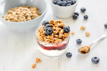 Healthy morning with granola breakfast on white kitchen table