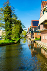 Traditional houses and small vessels in Holland town Volendam, Netherlands