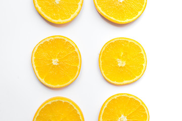 slices of oranges on white background bright pattern top view