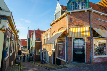 Fototapeta na wymiar Traditional houses and small vessels in Holland town Volendam, Netherlands