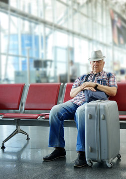Man sleeping on bench in airport