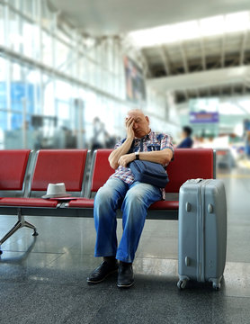 Man sleeping on bench in airport