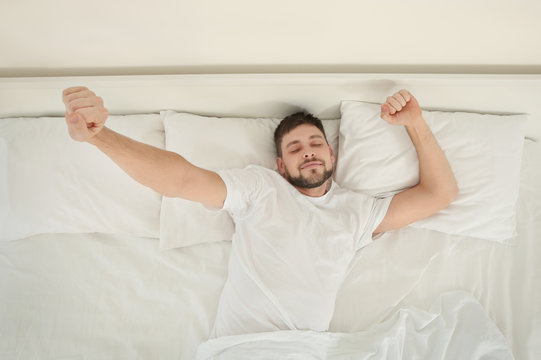 Young Attractive Man Waking Up In The Morning