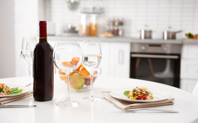 Wine bottle on served table at kitchen