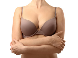Young woman in beige bra on white background
