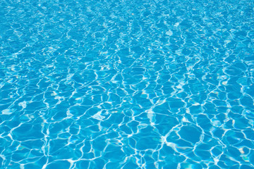 Fototapeta na wymiar Blue pool water background, wave. Clean and bright water in swimming pool.