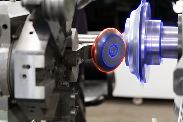 The CNC  spinning machine forming the part with the glowing edge lighting effect