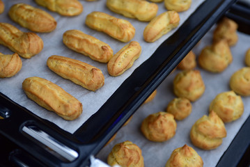 Freshly baked eclairs and profiteroles