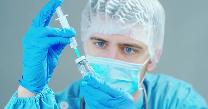 A doctor or scientist in laboratory holding a syringe with liquid vaccines for children or older adults, or cure animal diseases. Concept:diseases,medical care,science, anesthesia,euthanasia,diabetes.