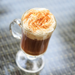 Irish coffee in an outdoor bar. Concept of St Patrick holiday. Holiday background