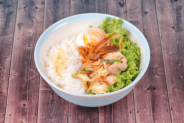 Japanese rice topped boil eggs and fried pork.