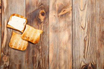 Breakfast, toast and coffee on a wooden background