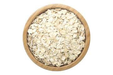 Oats in wooden bowl isolated top view on white