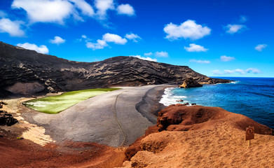 View into a volcanic crater with its green lake near El Golfo, Lanzarote island, Spain
