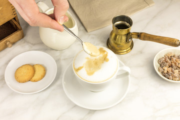 Fototapeta na wymiar Mixing milk and coffee with spoon