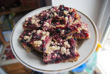rustic simple crumble on plate for breakfast with raspberries, blueberries