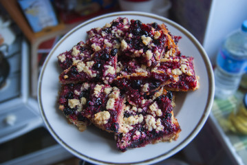 rustic simple crumble on plate for breakfast with raspberries, blueberries