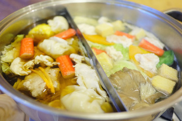 Double flavor hot pot on wood table