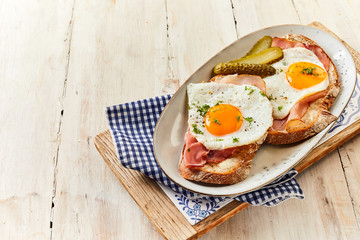Eggs cooked sunny side up with ham on bread
