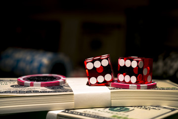 Red dices on chip and dollar bills, casino concept