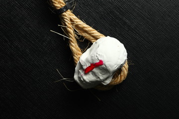 The artificial plaster miniature toy skull and red color liquid put on the manila rope.